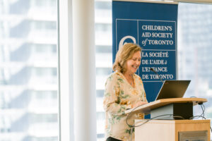 Woman delivering keynote at podium.